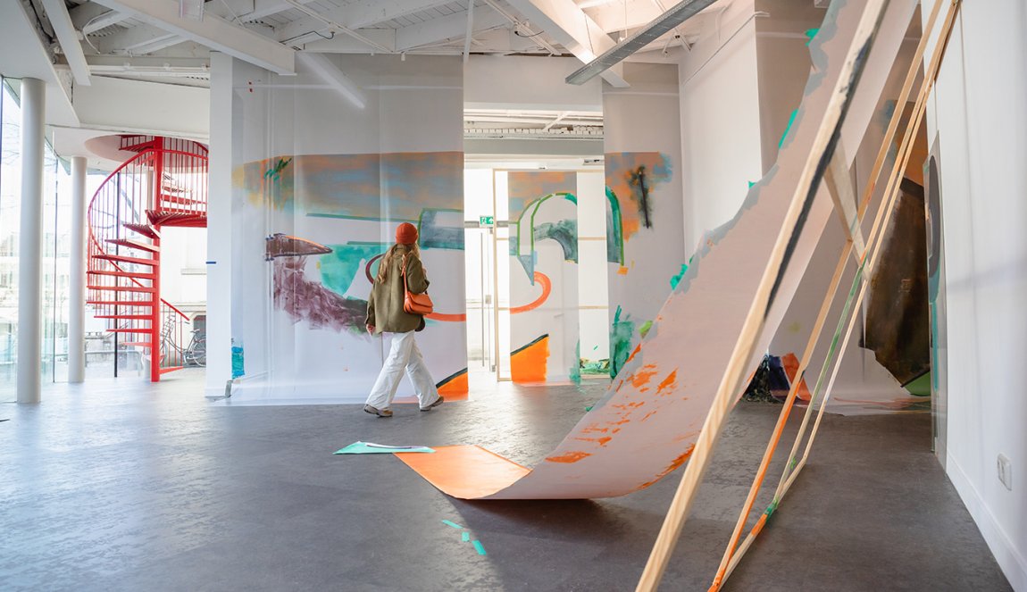 Woman walks through exhibition in Enschede